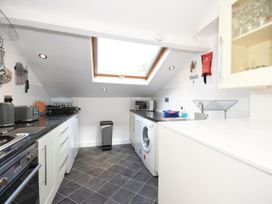A kitchen with appliances and a skylight at Seahorse in Filey