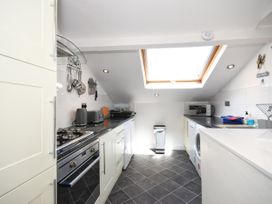 A kitchen with an oven and microwave at Seahorse in Filey