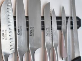A collection of knives on a magnetic strip in a kitchen at Seahorse in Filey