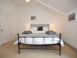 A bedroom with a bed and a lamp at Seahorse in Filey