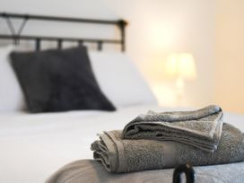 A bedroom with a bed and towels at Seahorse in Filey