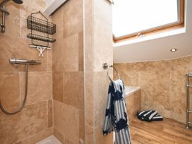 A bathroom featuring a shower and bathtub at Seahorse in Filey