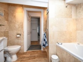 A bathroom with a toilet and bathtub at Seahorse in Filey