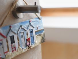 A beach hut decoration hanging on a hook at Seahorse in Filey