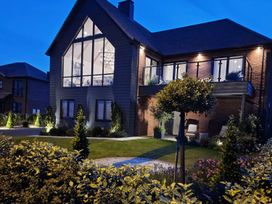 A house with a balcony and garden at Calm Waters Luxury Beach House in Bridlington