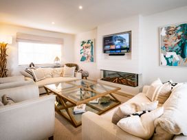 A living room with sofa and coffee table at Calm Waters Luxury Beach House in Bridlington