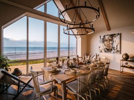 A dining room with a table set for a meal at Calm Waters Luxury Beach House in Bridlington
