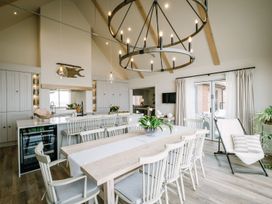 A kitchen with a dining table and chairs at Calm Waters Luxury Beach House in Bridlington