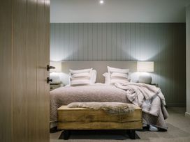 A bedroom with a bed and bedside tables at Calm Waters Luxury Beach House Bridlington