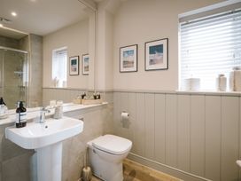 A bathroom with a sink and toilet at Calm Waters Luxury Beach House in Bridlington
