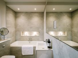 A bathroom with a bathtub and sink at Calm Waters Luxury Beach House in Bridlington