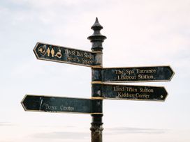 A directional sign with multiple location options at Calm Waters Luxury Beach House in Bridlington
