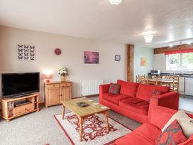 A living room with a television and sofa at 21 Tamar & St. Anns Cottages Honicombe Park near St. Ann's Chapel, Cornwall