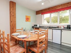 A kitchen with a dining table and chairs at 21 Tamar & St. Anns Cottages, Honicombe Park near St. Ann's Chapel, Cornwall