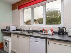 A kitchen with a sink and appliances at 21 Tamar & St. Anns Cottages Honicombe Park near St. Ann's Chapel, Cornwall
