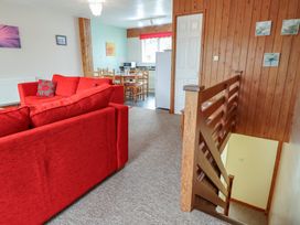 A living room with a sofa and dining area at 21 Tamar & St. Anns Cottages, Honicombe Park near St. Ann's Chapel, Cornwall