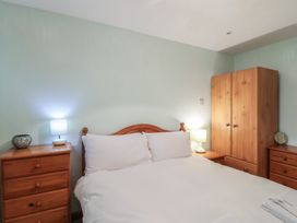 A bedroom with a bed and furniture at 21 Tamar & St. Anns Cottages, Honicombe Park near St. Ann's Chapel, Cornwall
