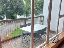A balcony with a table and chairs at 21 Tamar & St. Anns Cottages Honicombe Park near St. Ann's Chapel, Cornwall