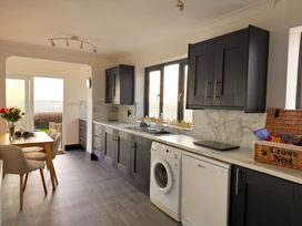 A kitchen with cabinets and appliances at Crows Nest Dawlish