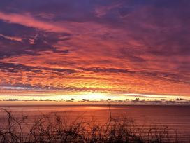 A sunset over the ocean with clouds at Crows Nest Dawlish in Dawlish