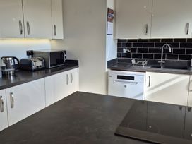 A kitchen with appliances including kettle, toaster, and microwave at 54 swallow road