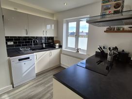 A kitchen with modern appliances and a window at 54 swallow road