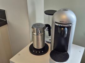 A coffee maker and milk frother on a counter at 54 swallow road