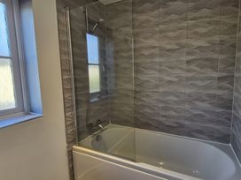 A bathroom with a bathtub and shower at 54 swallow road