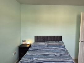 A bedroom with a bed and nightstand at 54 swallow road