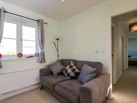 A living room with a sofa and window at Swallows Nest in Bourton-On-The-Water