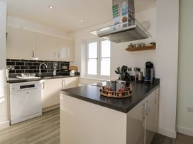 A kitchen with appliances and utensils at Swallows Nest Bourton-On-The-Water