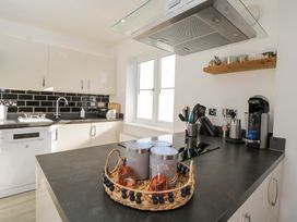 A kitchen with a sink and appliances at Swallows Nest in Bourton-On-The-Water