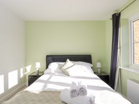 A bedroom with a bed and nightstand at Swallows Nest Bourton-On-The-Water
