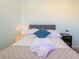 A bedroom with a bed and bedside table at Swallows Nest Bourton-On-The-Water