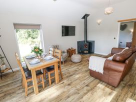 A living room with a sofa and dining table at Cadno in Llanybydder