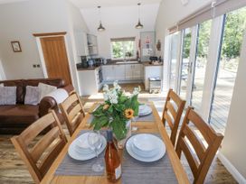 A dining room with a table set for a meal at Cadno in Llanybydder