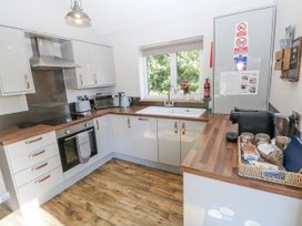 A kitchen with cabinets and appliances at Cadno in Llanybydder