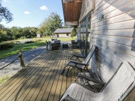 A deck area with chairs and table at Cadno Llanybydder