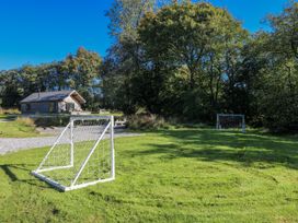 A cabin with soccer goals on a grassy field at Cadno in Llanybydder