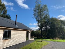 A house with a chimney and pathway at Cadno Aber near Llanybydder