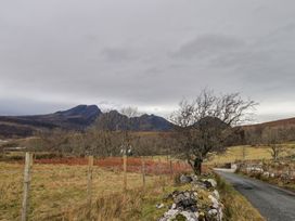 A landscape featuring mountains, a tree, and a road at The Pod at Greenbank Isle of Skye