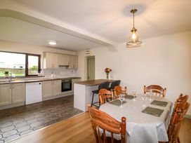 A kitchen with a dining area and appliances at Shamrock House