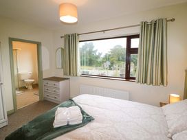 A bedroom with a bed and an adjoining bathroom at Shamrock House