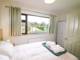 A bedroom with a bed and window at Shamrock House
