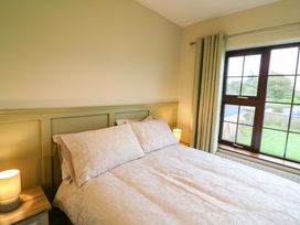 A bedroom with a bed and window at Shamrock House
