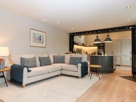 A living room with a sofa and kitchen island at Duke's Barn in Blackawton near Dartmouth