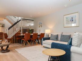A living room with a sofa and dining area at Duke's Barn in Blackawton near Dartmouth