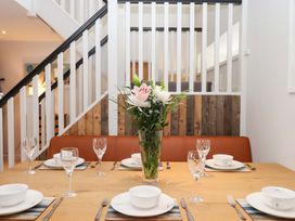 A dining room with a table set for dinner at Duke's Barn Blackawton near Dartmouth