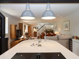 A kitchen with an island and a living area at Duke's Barn Blackawton near Dartmouth