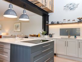 A kitchen with an island and modern appliances at Duke's Barn in Blackawton near Dartmouth